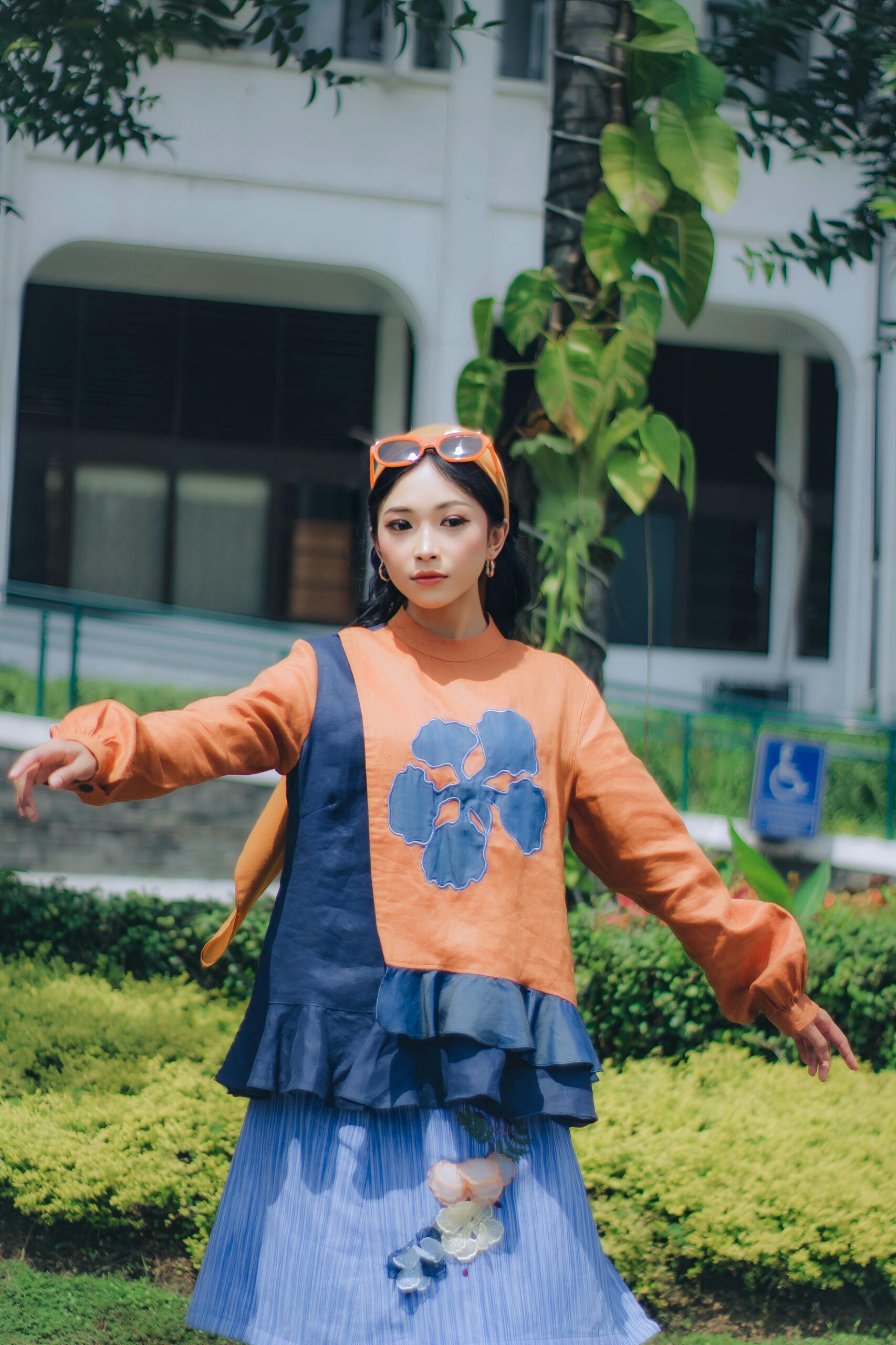 Stylish woman posing outdoors in a colorful outfit, Bandung, Indonesia.