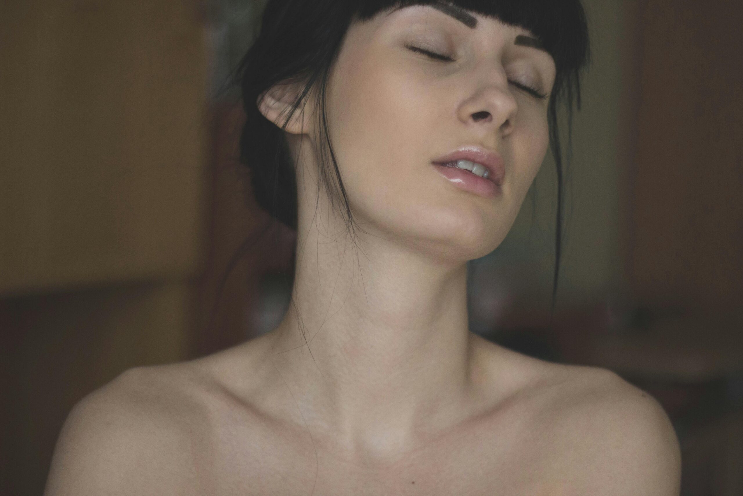 Close-up portrait of a woman with closed eyes, showcasing natural beauty and elegance.